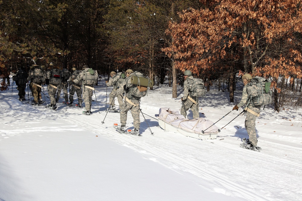 Cold-Weather Operations Course class 21-04 students conduct field training in snowshoes, pulling sleds