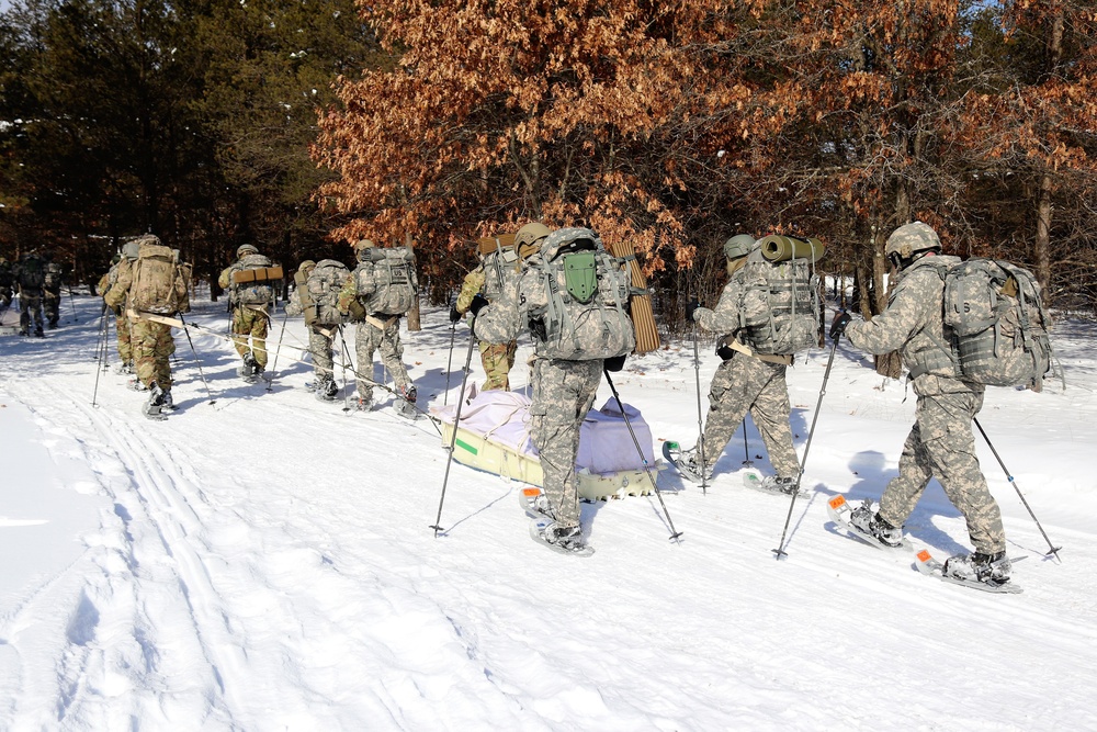 Cold-Weather Operations Course class 21-04 students conduct field training in snowshoes, pulling sleds