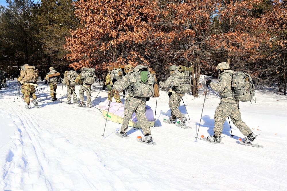 Cold-Weather Operations Course class 21-04 students conduct field training in snowshoes, pulling sleds