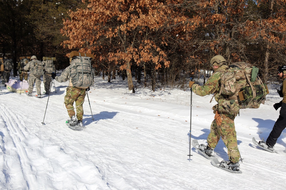 Cold-Weather Operations Course class 21-04 students conduct field training in snowshoes, pulling sleds