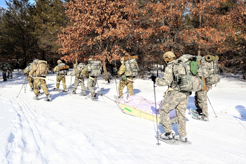 Cold-Weather Operations Course class 21-04 students conduct field training in snowshoes, pulling sleds