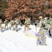 Cold-Weather Operations Course class 21-04 students conduct field training in snowshoes, pulling sleds
