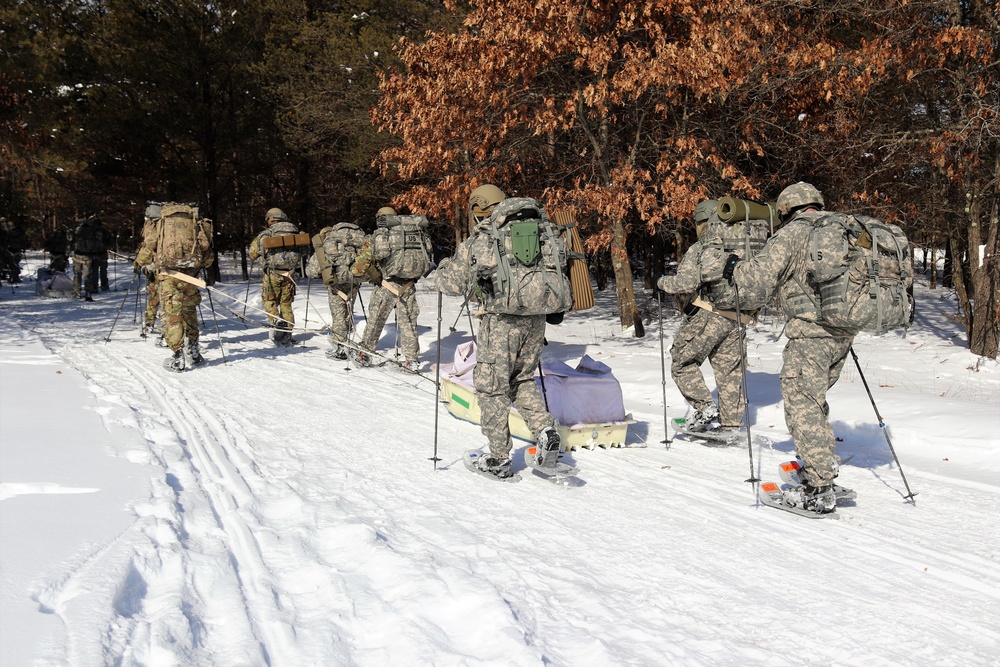 Cold-Weather Operations Course class 21-04 students conduct field training in snowshoes, pulling sleds
