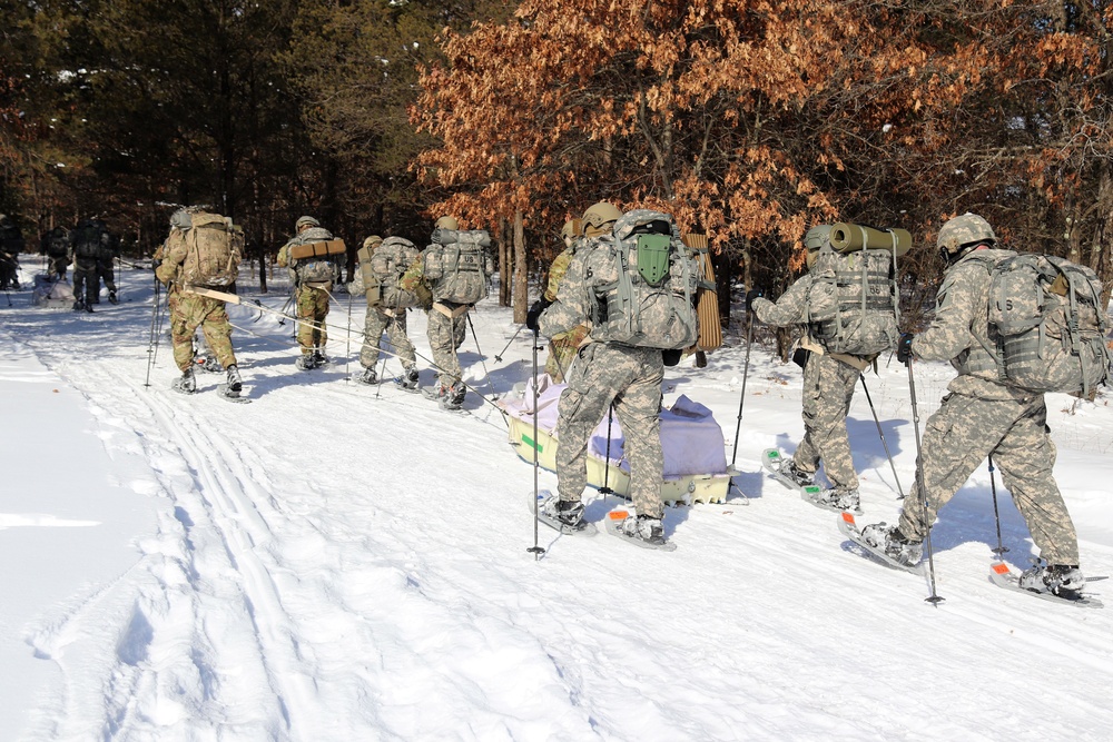 Cold-Weather Operations Course class 21-04 students conduct field training in snowshoes, pulling sleds