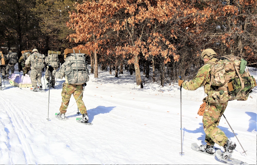 Cold-Weather Operations Course class 21-04 students conduct field training in snowshoes, pulling sleds