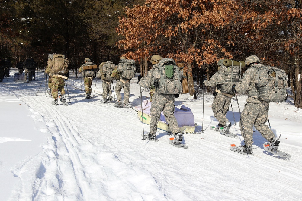 Cold-Weather Operations Course class 21-04 students conduct field training in snowshoes, pulling sleds