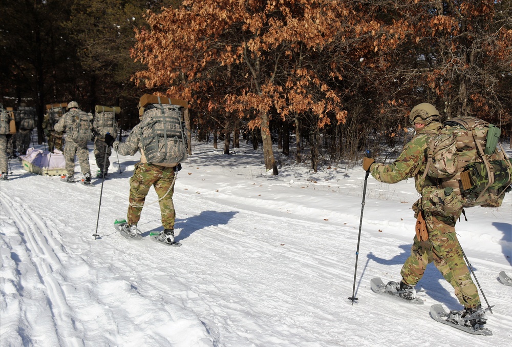 Cold-Weather Operations Course class 21-04 students conduct field training in snowshoes, pulling sleds