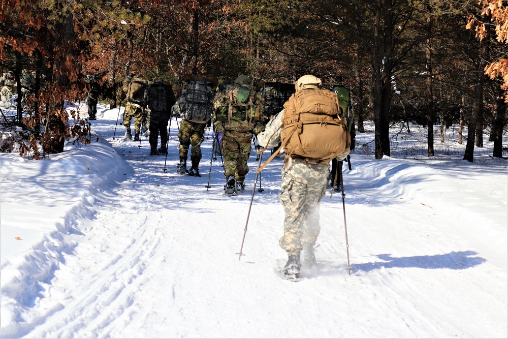 Cold-Weather Operations Course class 21-04 students conduct field training in snowshoes, pulling sleds