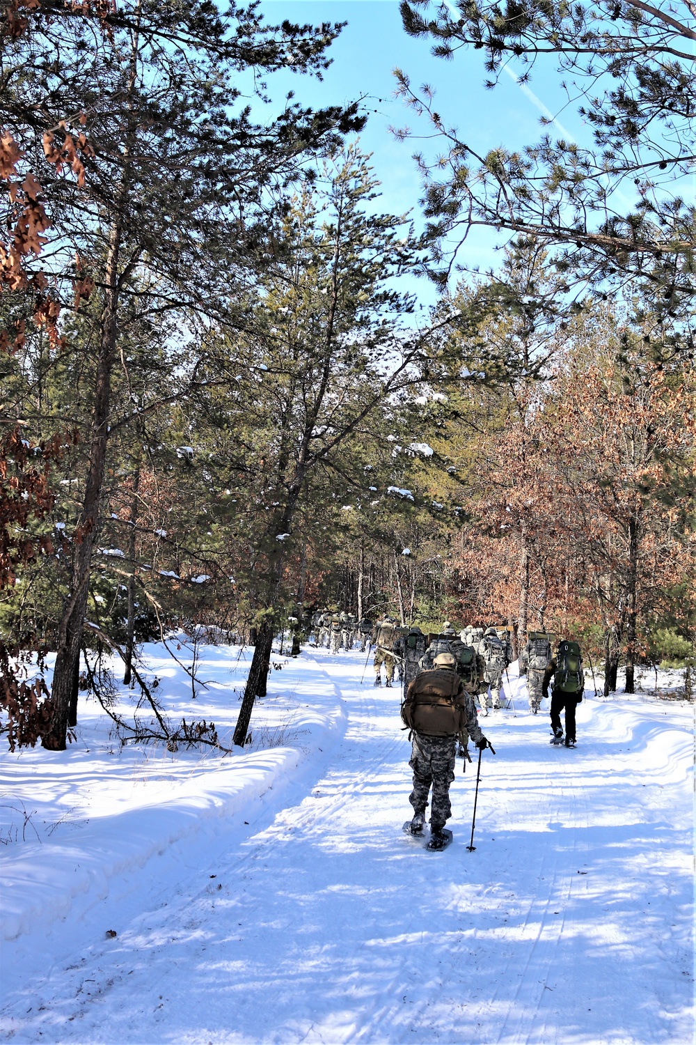 Cold-Weather Operations Course class 21-04 students conduct field training in snowshoes, pulling sleds