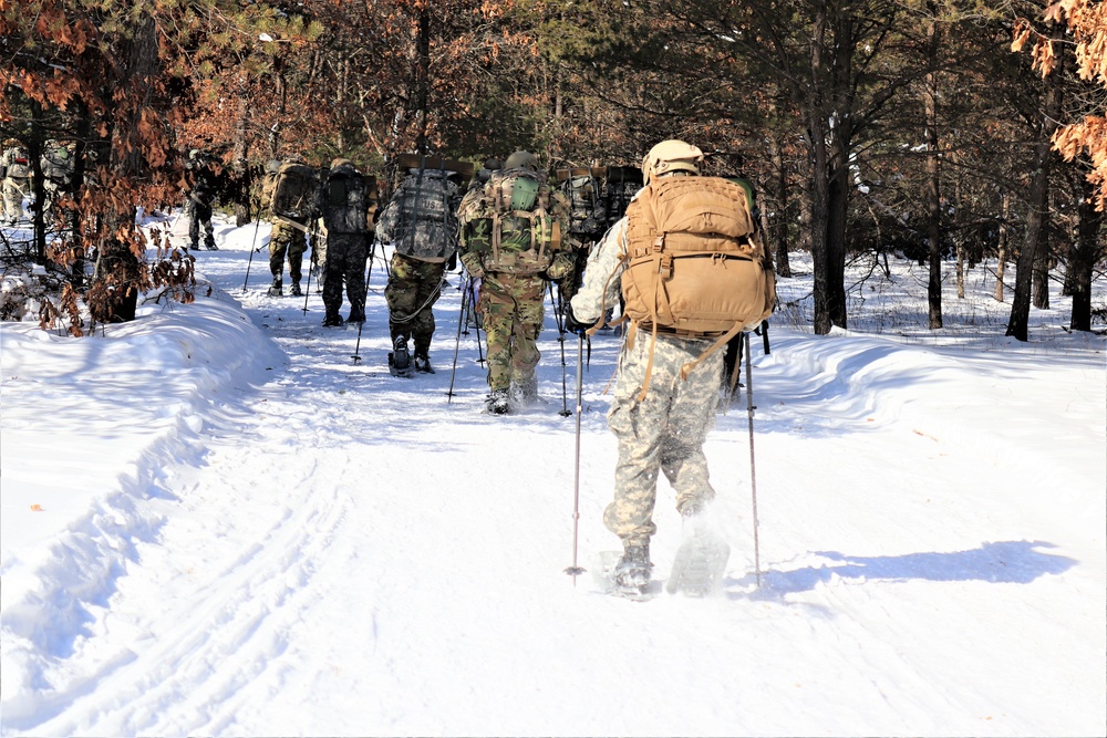 Cold-Weather Operations Course class 21-04 students conduct field training in snowshoes, pulling sleds