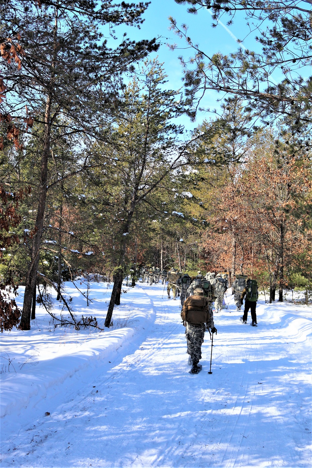 Cold-Weather Operations Course class 21-04 students conduct field training in snowshoes, pulling sleds