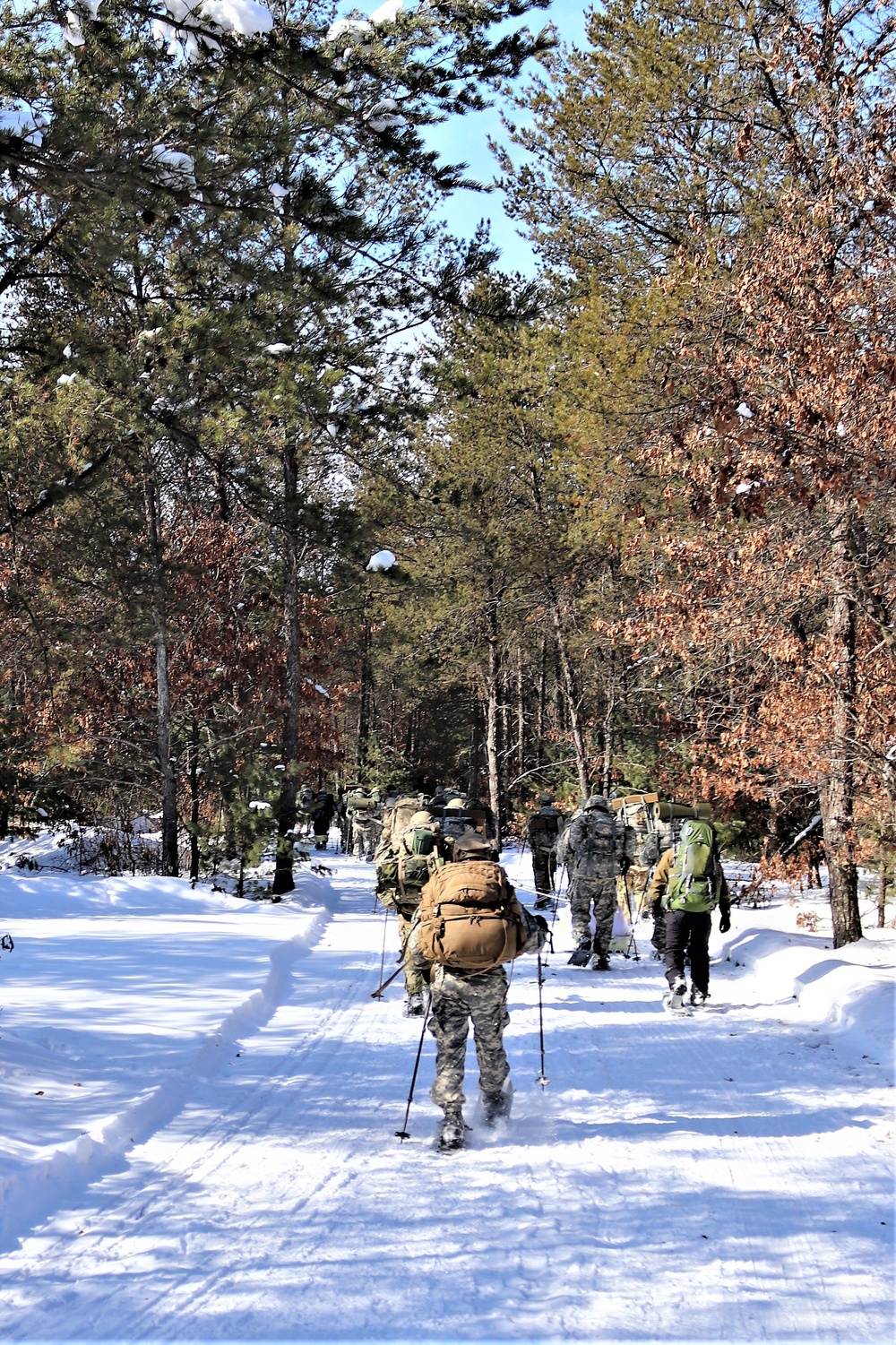 Cold-Weather Operations Course class 21-04 students conduct field training in snowshoes, pulling sleds