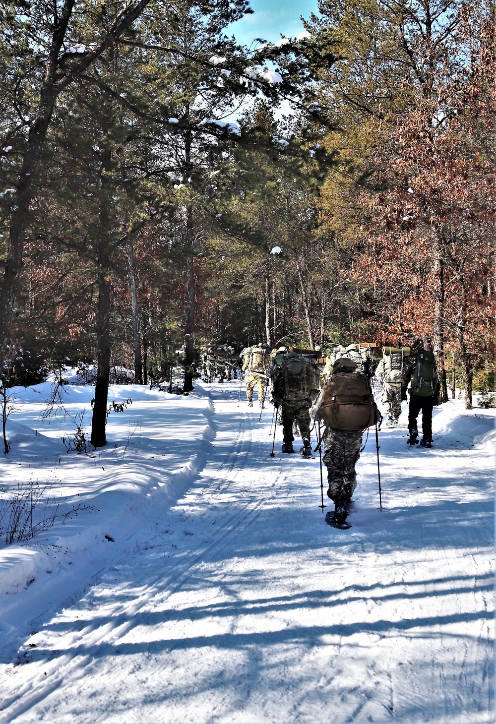 Cold-Weather Operations Course class 21-04 students conduct field training in snowshoes, pulling sleds