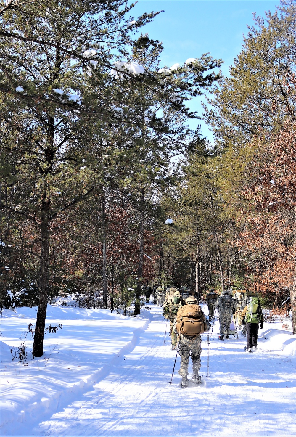 Cold-Weather Operations Course class 21-04 students conduct field training in snowshoes, pulling sleds