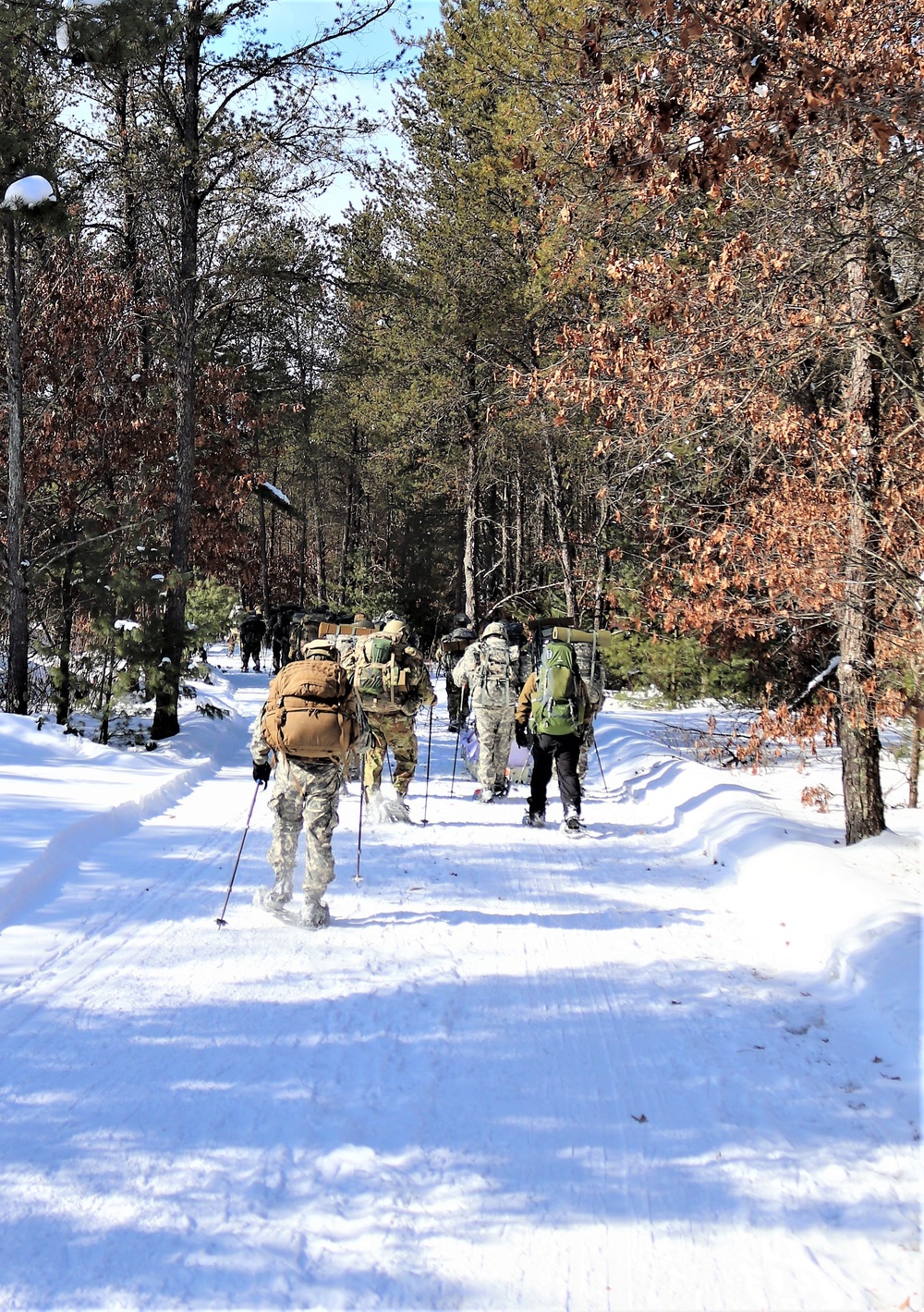Cold-Weather Operations Course class 21-04 students conduct field training in snowshoes, pulling sleds