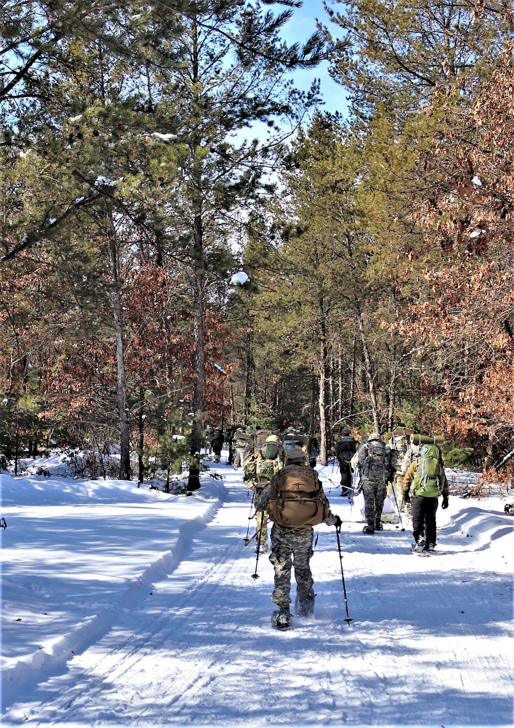Cold-Weather Operations Course class 21-04 students conduct field training in snowshoes, pulling sleds