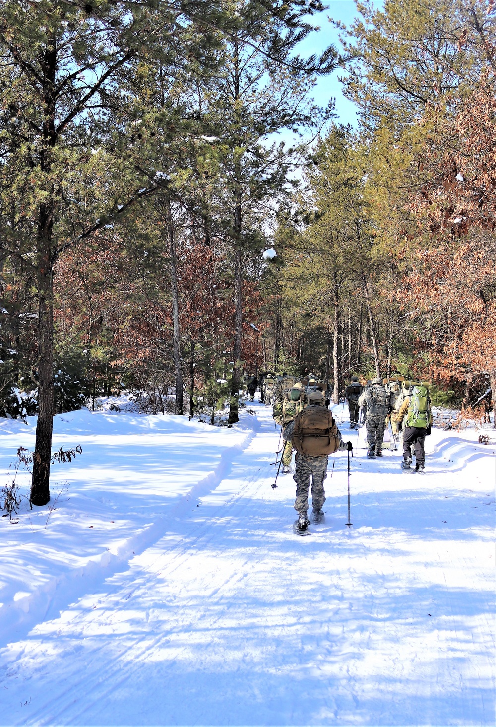 Cold-Weather Operations Course class 21-04 students conduct field training in snowshoes, pulling sleds