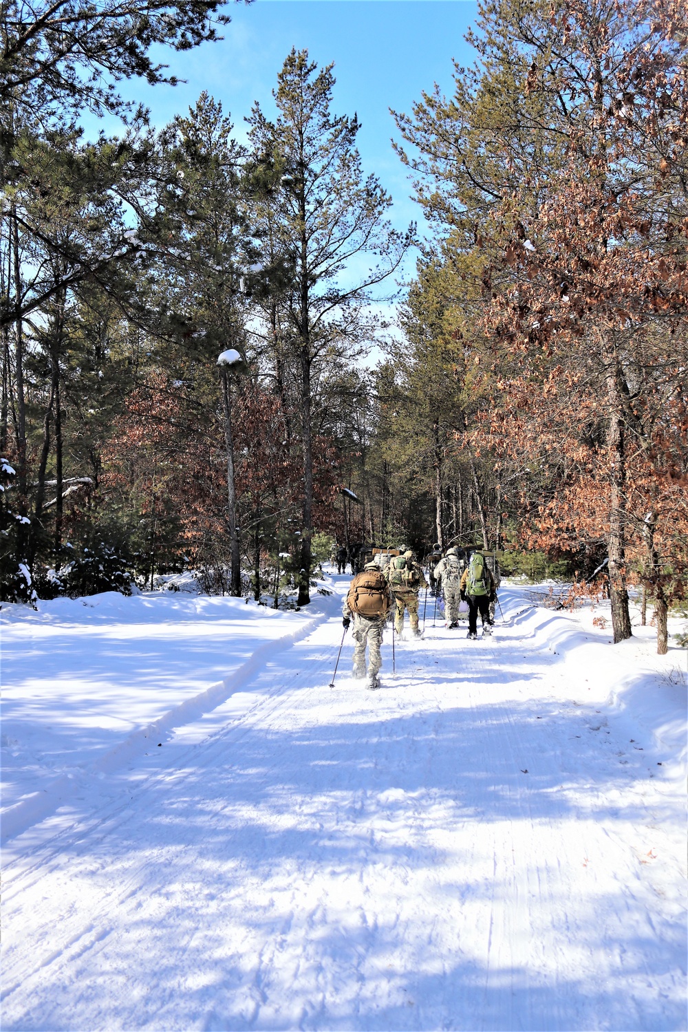 Cold-Weather Operations Course class 21-04 students conduct field training in snowshoes, pulling sleds