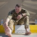 Soldier Inspects Blisters After Norwegian Foot March