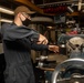 Sailor works on equipment