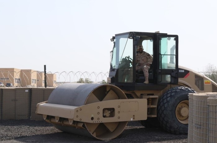 Task Force Iron Castle Engineers and Kuwaiti Land Force Soldiers from the Land Forces Institute collaborate on a forward operating base (FOB) construction project.