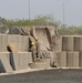 Task Force Iron Castle Engineers and Kuwaiti Land Force Soldiers from the Land Forces Institute collaborate on a forward operating base (FOB) construction project