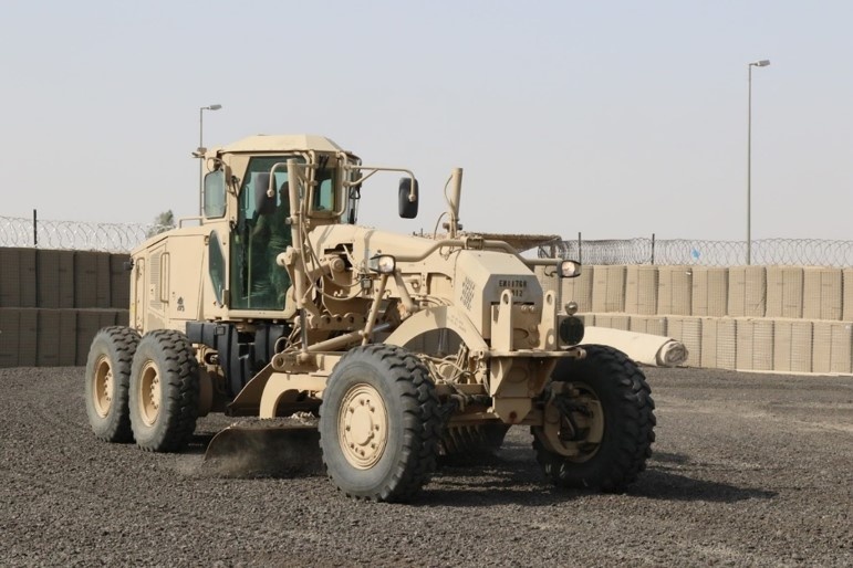 Task Force Iron Castle Engineers and Kuwaiti Land Force Soldiers from the Land Forces Institute collaborate on a forward operating base (FOB) construction project