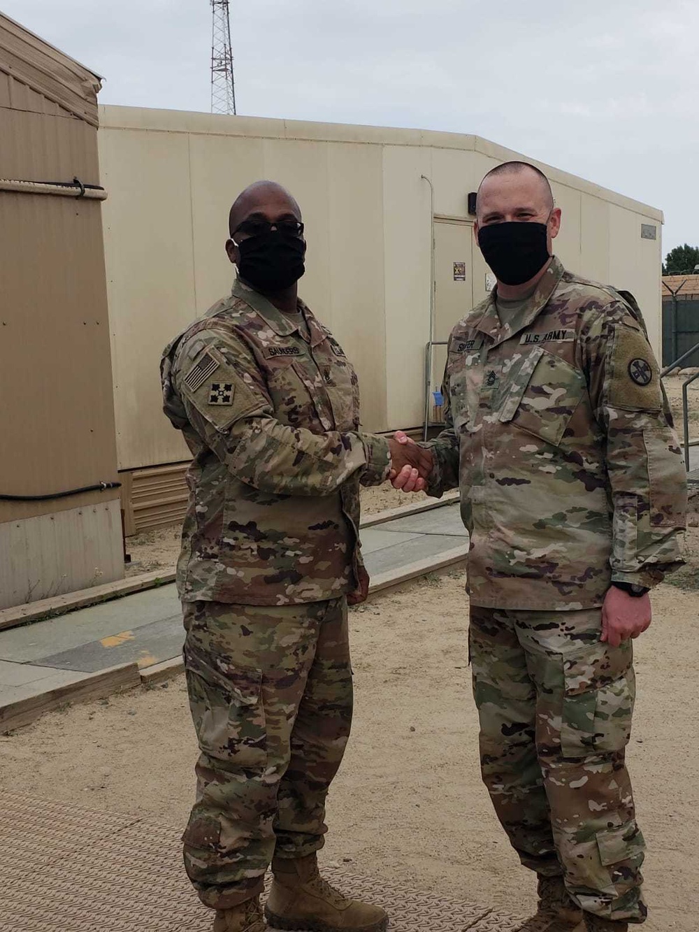 Brigadier General Tina B. Boyd, the G6 of U.S. Army Central awards the Theater Engineer Brigade's Master Sergeant Brad Shaffer with her coin for his hard work in helping establish USARCENT's Signal University.