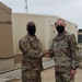 Brigadier General Tina B. Boyd, the G6 of U.S. Army Central awards the Theater Engineer Brigade's Master Sergeant Brad Shaffer with her coin for his hard work in helping establish USARCENT's Signal University.