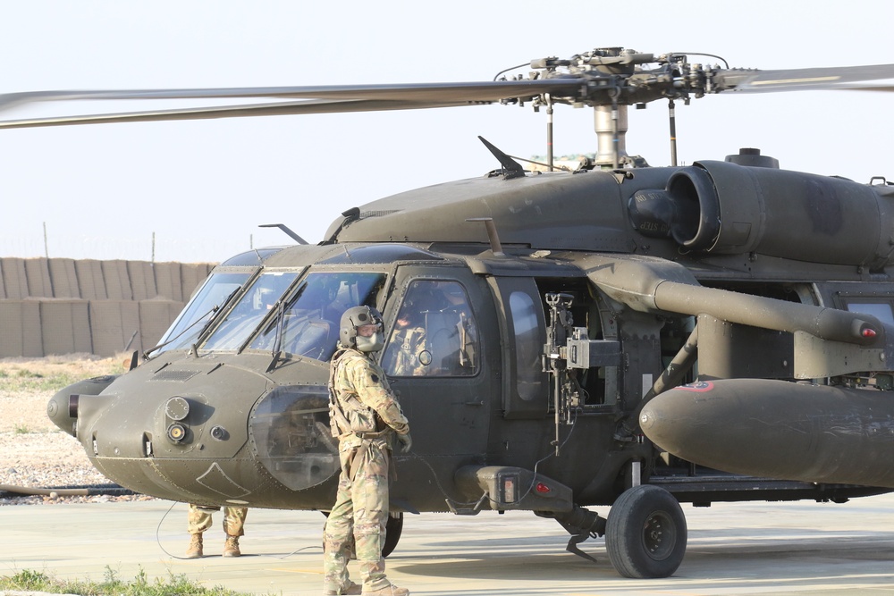 Soldiers preparing Black Hawk for take off