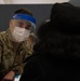 Service members inoculate community members on the opening day of the Jersey City, NJ CVC