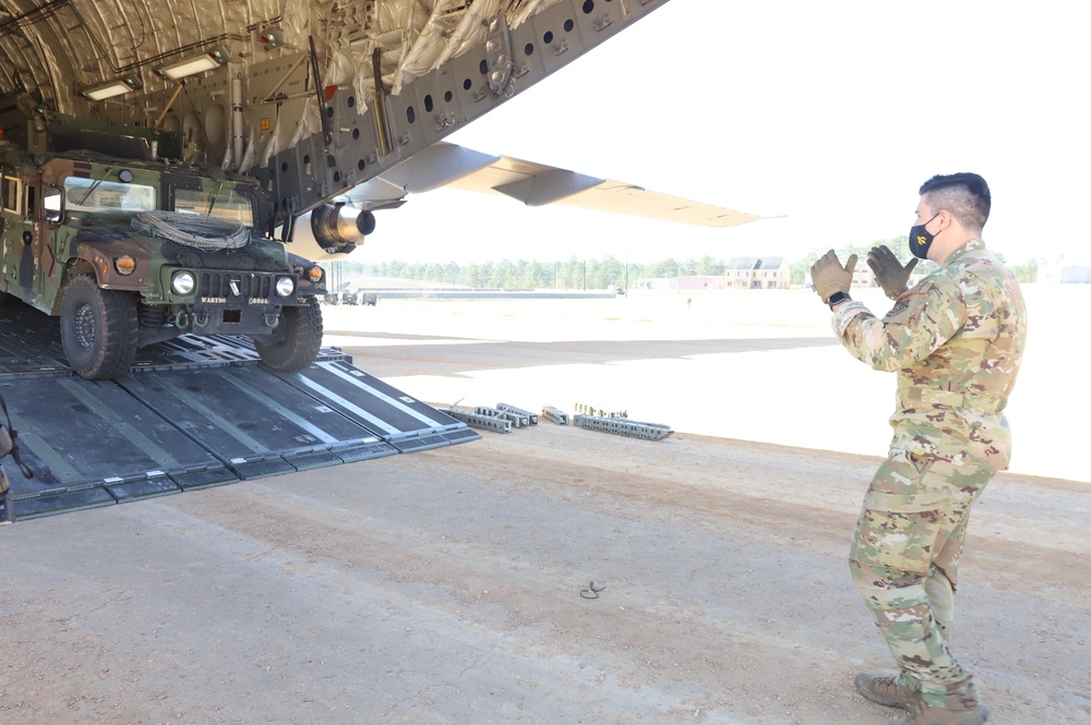 Airman guides Humvee off transport plane during JRTC 21-05