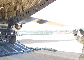 Airman guides Humvee off transport plane during JRTC 21-05