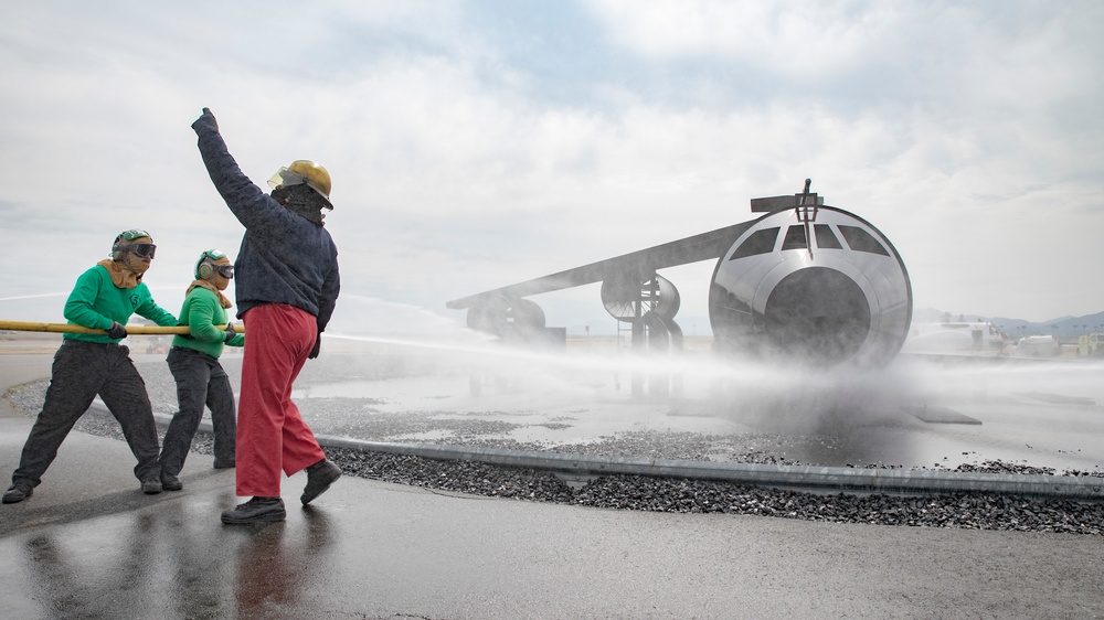 U.S. Navy Sailors with Fleet Logistics Support Squadron (VRC) 30, DET-5, Carrier Air Wing Five (CVW-5) conduct an airfield firefighting exercise