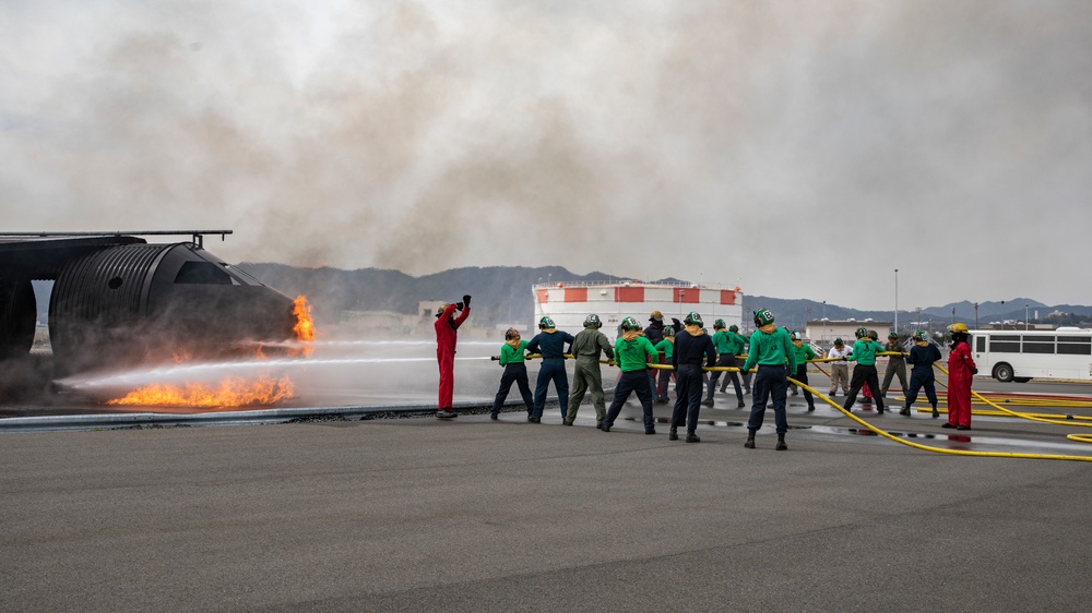 U.S. Navy Sailors with Fleet Logistics Support Squadron (VRC) 30, DET-5, Carrier Air Wing Five (CVW-5) conduct an airfield firefighting exercise