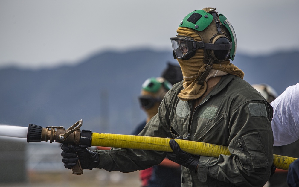 U.S. Navy Sailors with Fleet Logistics Support Squadron (VRC) 30, DET-5, Carrier Air Wing Five (CVW-5) conduct an airfield firefighting exercise