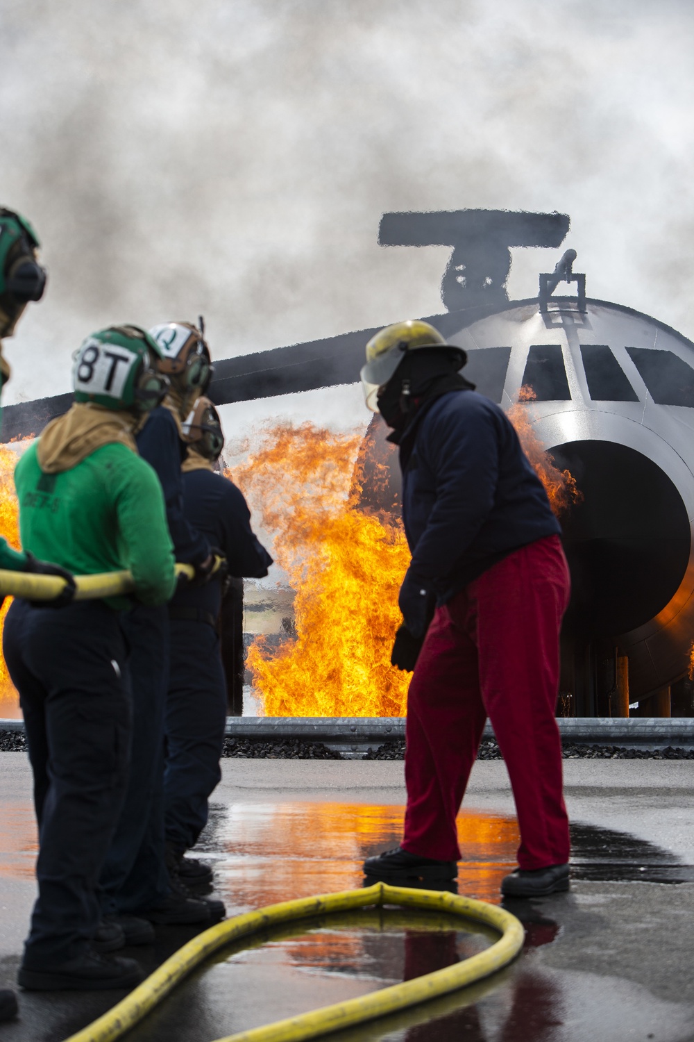 U.S. Navy Sailors with Fleet Logistics Support Squadron (VRC) 30, DET-5, Carrier Air Wing Five (CVW-5) conduct an airfield firefighting exercise