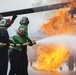 U.S. Navy Sailors with Fleet Logistics Support Squadron (VRC) 30, DET-5, Carrier Air Wing Five (CVW-5) conduct an airfield firefighting exercise