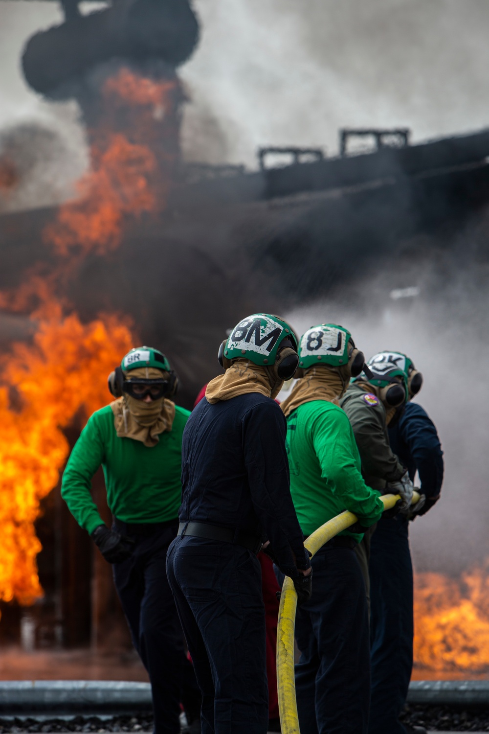 U.S. Navy Sailors with Fleet Logistics Support Squadron (VRC) 30, DET-5, Carrier Air Wing Five (CVW-5) conduct an airfield firefighting exercise
