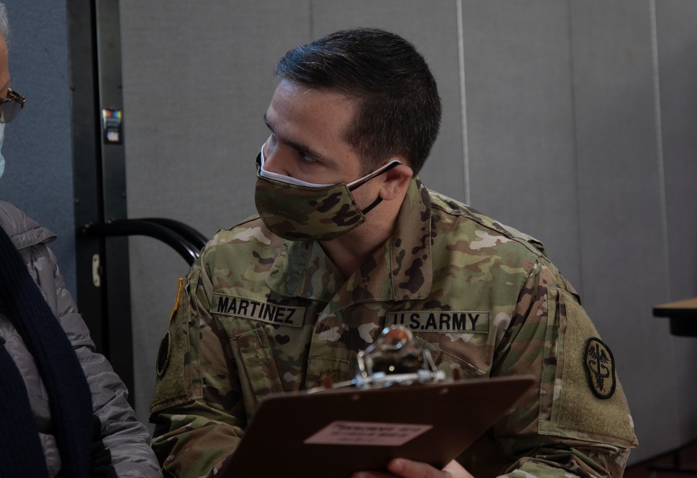 U.S. Service members inoculate community members on the opening day of the CVC in Paterson, NJ
