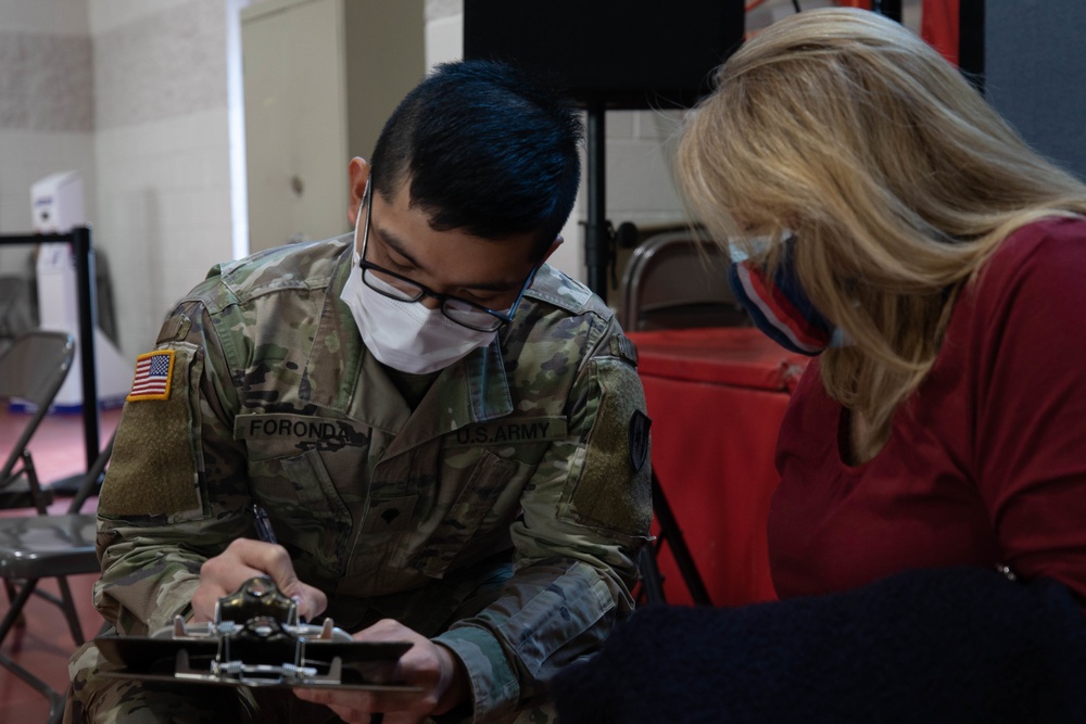 U.S. Service members inoculate community members on the opening day of the CVC in Paterson, NJ