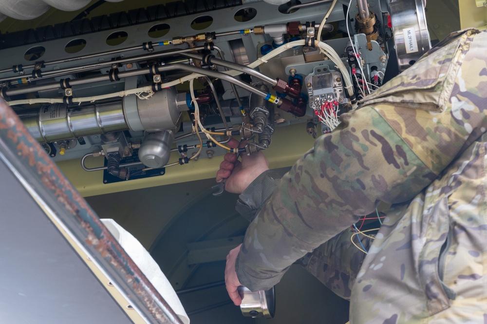 352d Special Operations Wing assist in repairing air-to-air refueling equipment on an Armée de l'Air et de l’Espace (French Air and Space Force) KC-130J