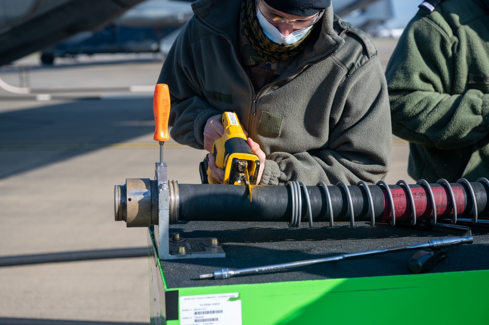 352d Special Operations Wing assist in repairing air-to-air refueling equipment on an Armée de l'Air et de l’Espace (French Air and Space Force) KC-130J