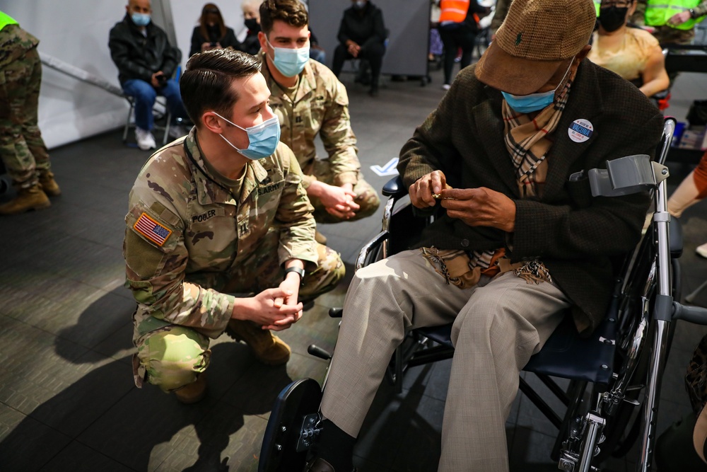 101st Airborne Division (Air Assault) Soldiers present a Vietnam Veteran with a challenge coin
