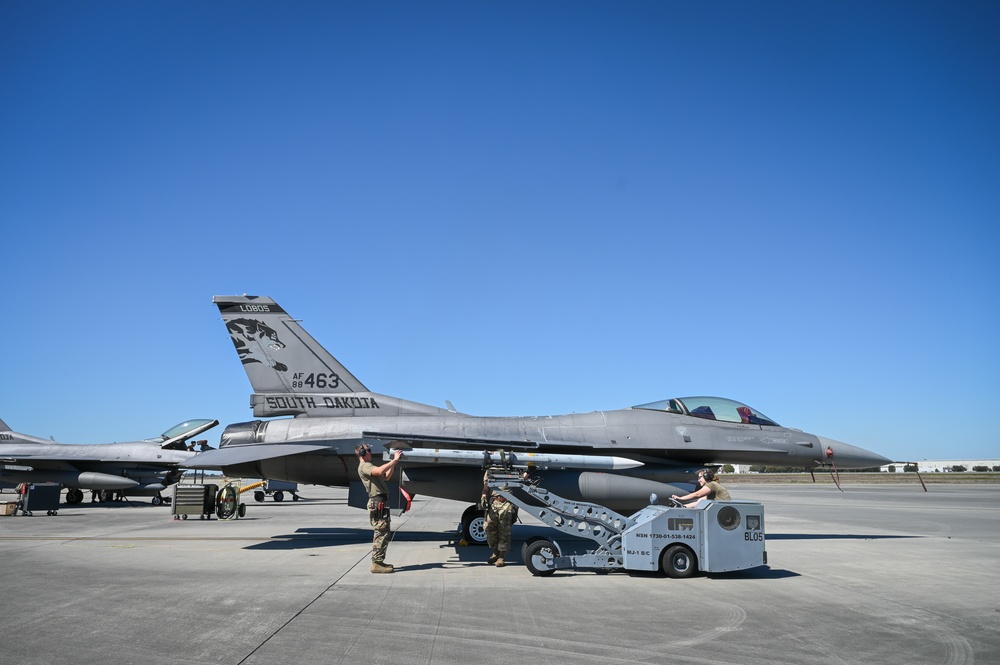 South Dakota Air Guardsmen load munitions onto F-16s