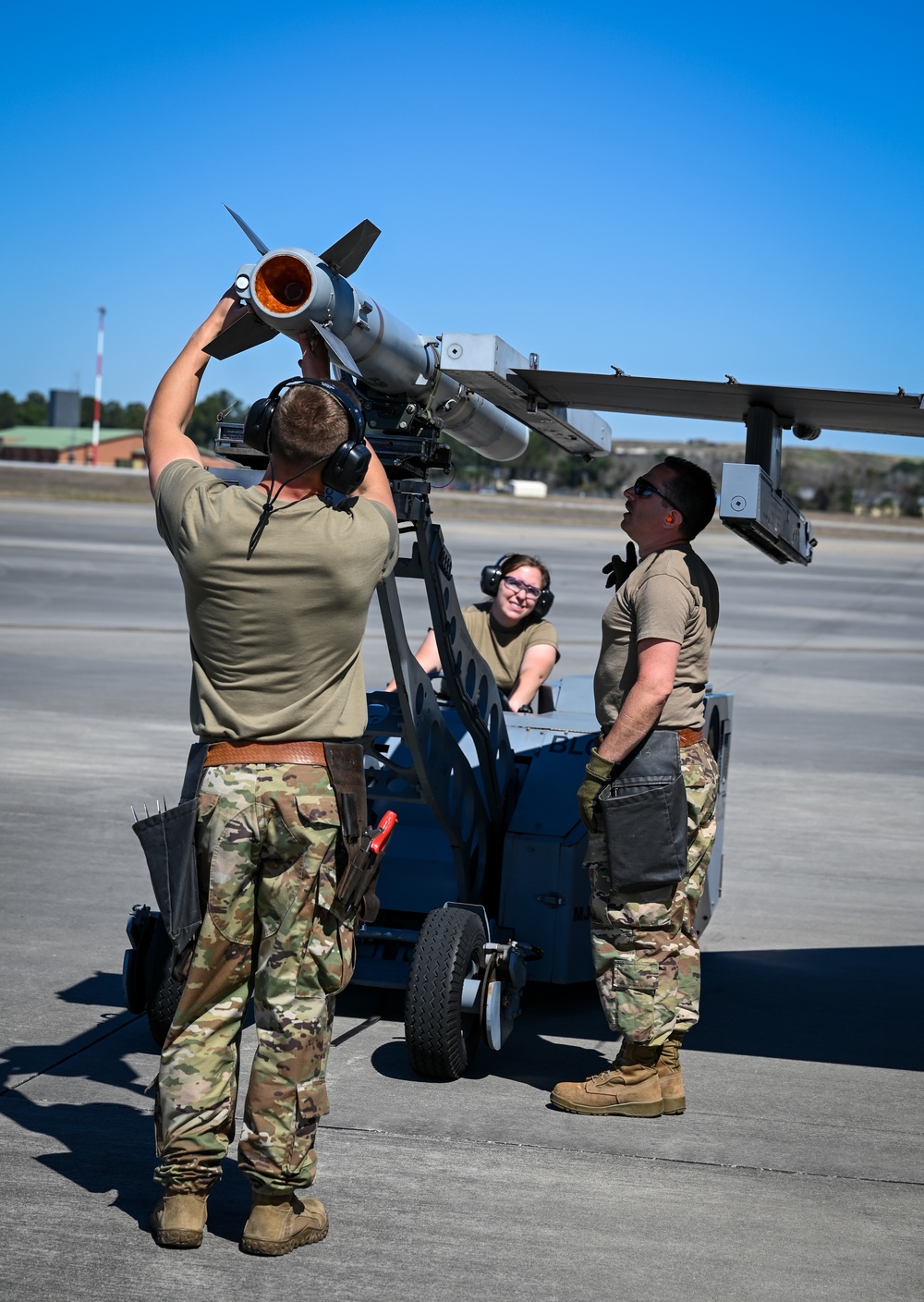 South Dakota Air Guardsmen load munitions on F-16s