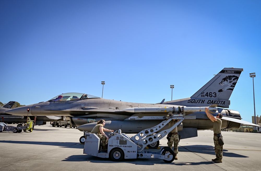 South Dakota Air Guardsmen load munitions on F-16s