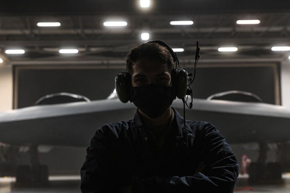 509th Aircraft Maintenance Squadron Airman poses in front of B-2 Spirit