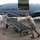 420th ABS supports Baltic Trident Exercise U.S. Air Force personnel are positioning a mobile boarding staircase next to a military aircraft on a flight line. The aircraft, marked 'U.S. Air FORCE' with tail number 0036, has its forward cargo/passenger door open with cargo visible inside. Several airmen in various uniforms and face masks are involved in ground operations.