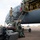 420th ABS supports Baltic Trident Exercise Military personnel in uniform are disembarking from a large U.S. Air Force aircraft via a mobile staircase on a flight line. Personnel are wearing face masks, suggesting this was taken during the COVID-19 pandemic period. Luggage and equipment bags are piled on the tarmac near the base of the stairs.